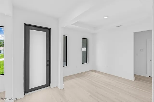 an empty room with windows and closet
