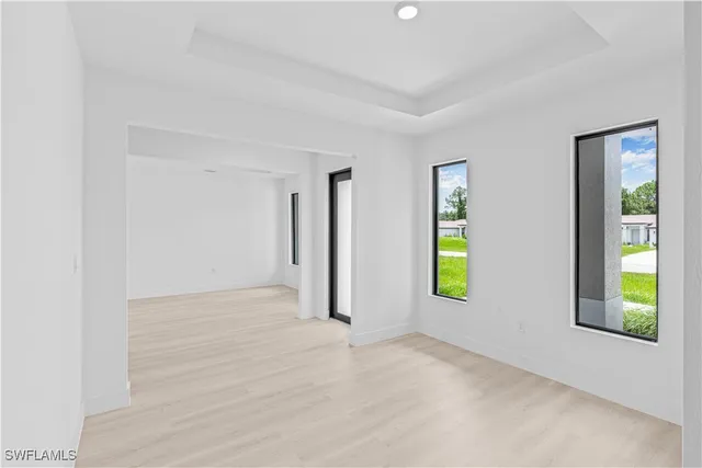 a view of an empty room with window and closet area