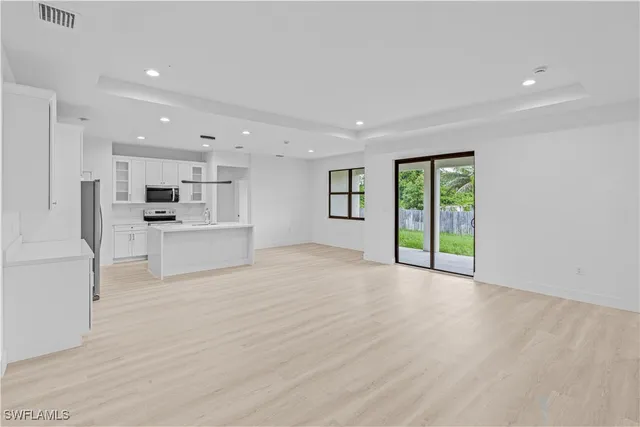 a view of kitchen with stainless steel appliances refrigerator oven and cabinets