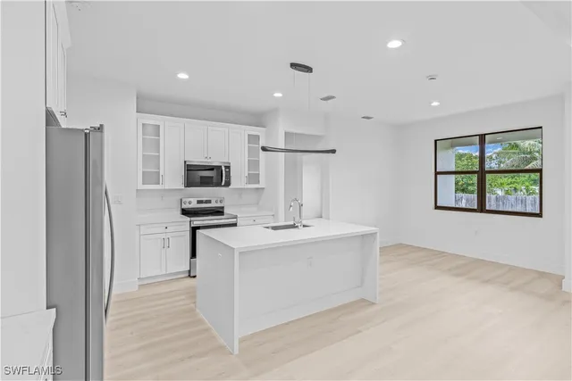 a kitchen with a refrigerator a stove top oven a sink and dishwasher