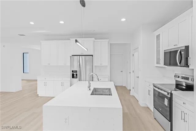 a kitchen with a sink a stove and refrigerator