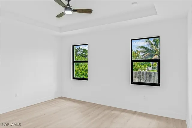 an empty room with windows and closet