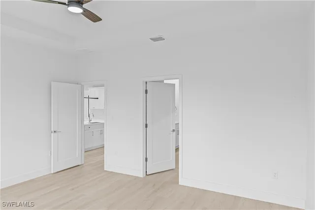 a view of a livingroom with wooden floor and a ceiling fan