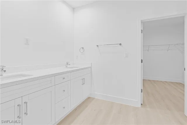 a view of a kitchen with white cabinets