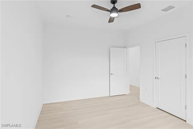 a view of a room with a ceiling fan