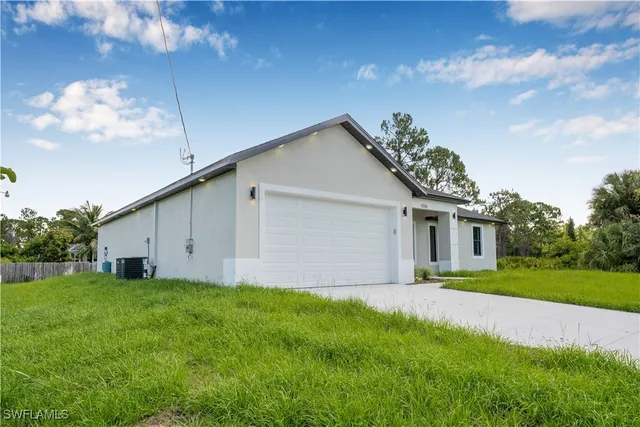 a front view of a house with a garden and yard