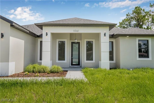 a front view of a house with a yard