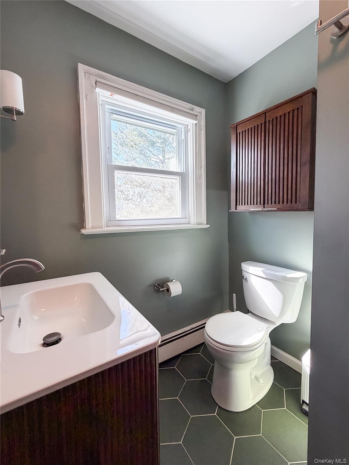 350 Smith Street Peekskill, NY 10566 - Photo 27 of 32 a bathroom with a sink toilet and window