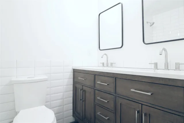 a bathroom with a toilet sink and mirror