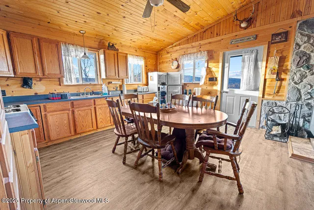a dining room with furniture and wooden floor