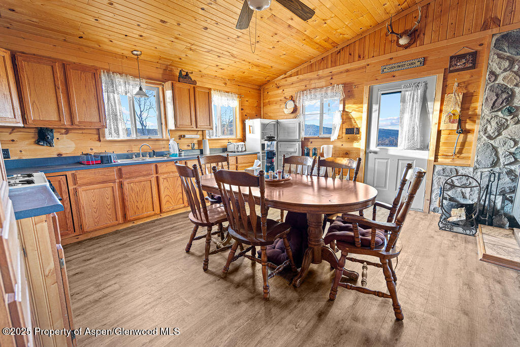 228 Eagle Loop Craig, CO 81625 - Photo 15 of 37 a dining hall with stainless steel appliances a dining table and chairs with wooden floor