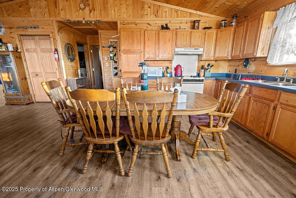 228 Eagle Loop Craig, CO 81625 - Photo 17 of 37 a view of a dining room with furniture window and wooden floor