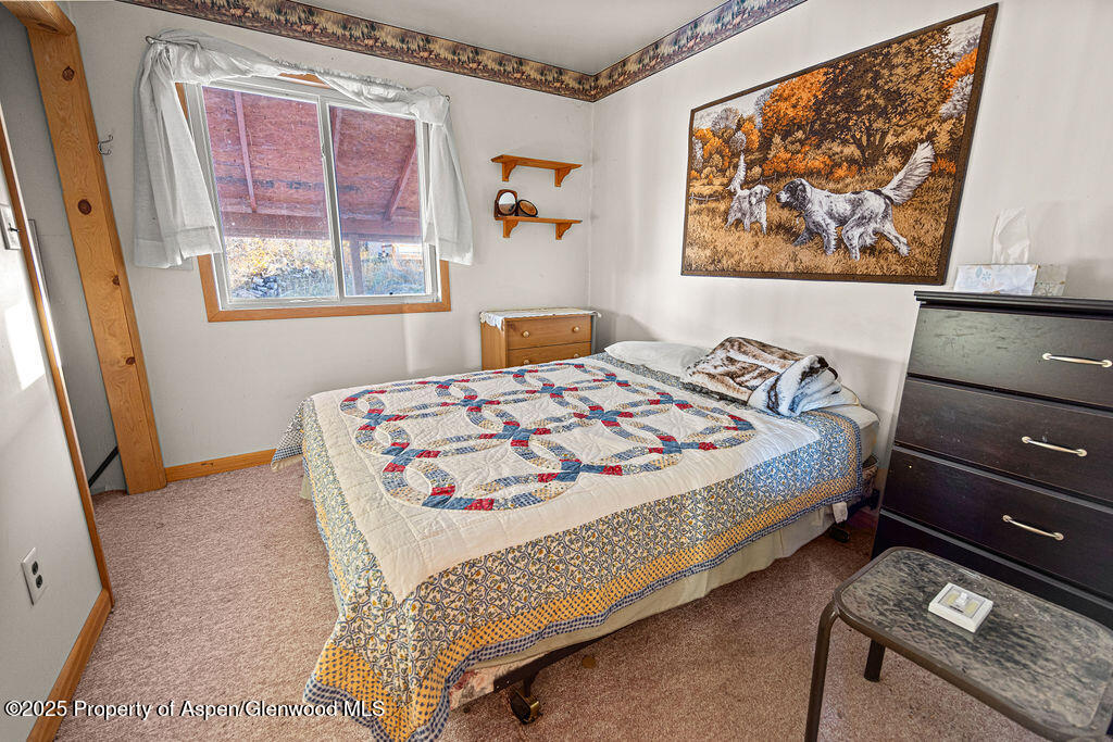 228 Eagle Loop Craig, CO 81625 - Photo 26 of 37 a bedroom with a bed and a window