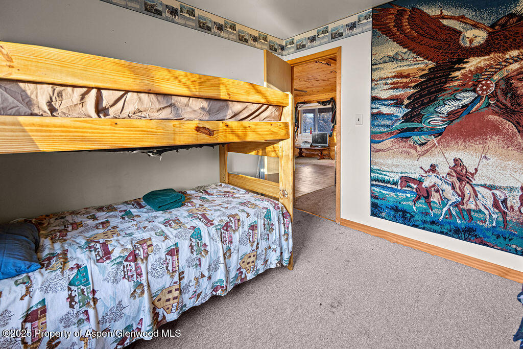 228 Eagle Loop Craig, CO 81625 - Photo 27 of 37 a bedroom with a bed and a painting on the wall