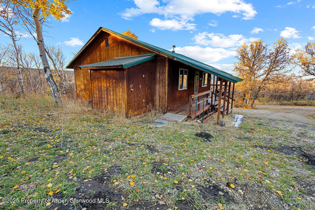 228 Eagle Loop Craig, CO 81625 - Photo 30 of 37 a backyard of a house with barbeque oven table and chairs