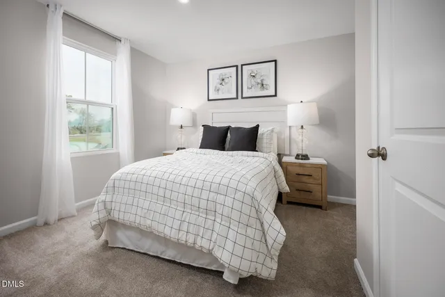 a spacious bedroom with a bed and a window