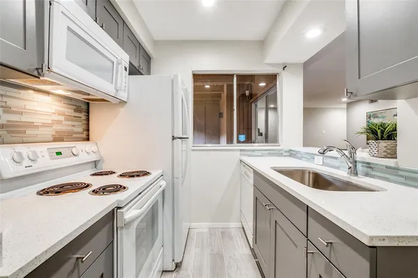 a kitchen that has a sink and a stove
