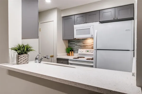 a kitchen with stainless steel appliances a refrigerator and cabinets
