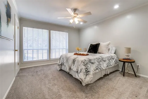 a bedroom with a bed and a large window