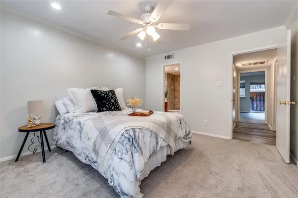 a bedroom with bed and a chandelier
