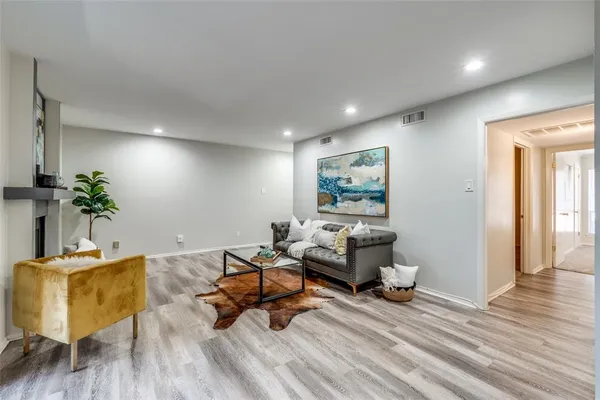 a living room with furniture and wooden floor