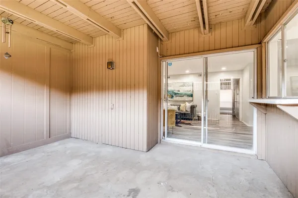 a view of a room with wooden walls and door