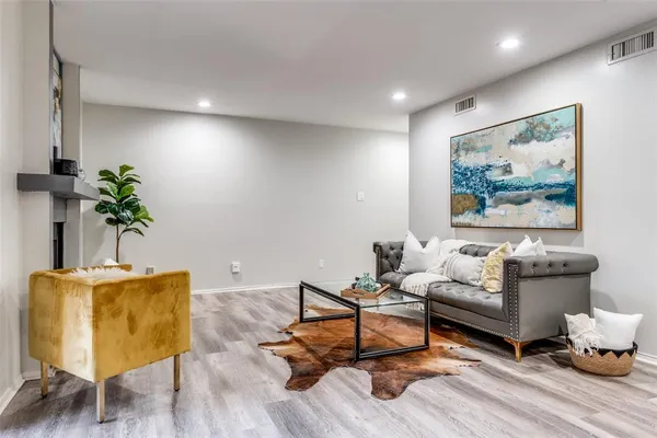 a living room with furniture and wooden floor