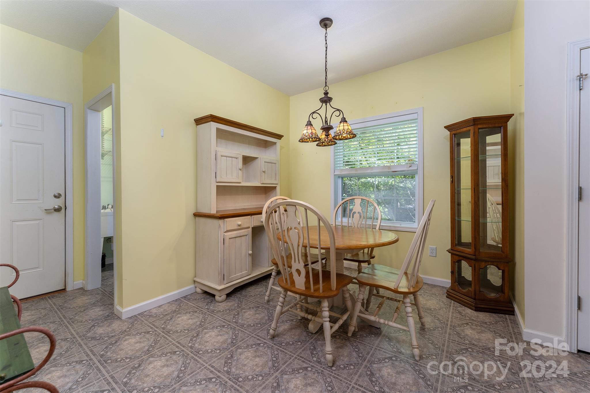 488 Anders Road Zirconia, NC 28790 - Photo 12 of 48 a view of a dining room with furniture window and outside view