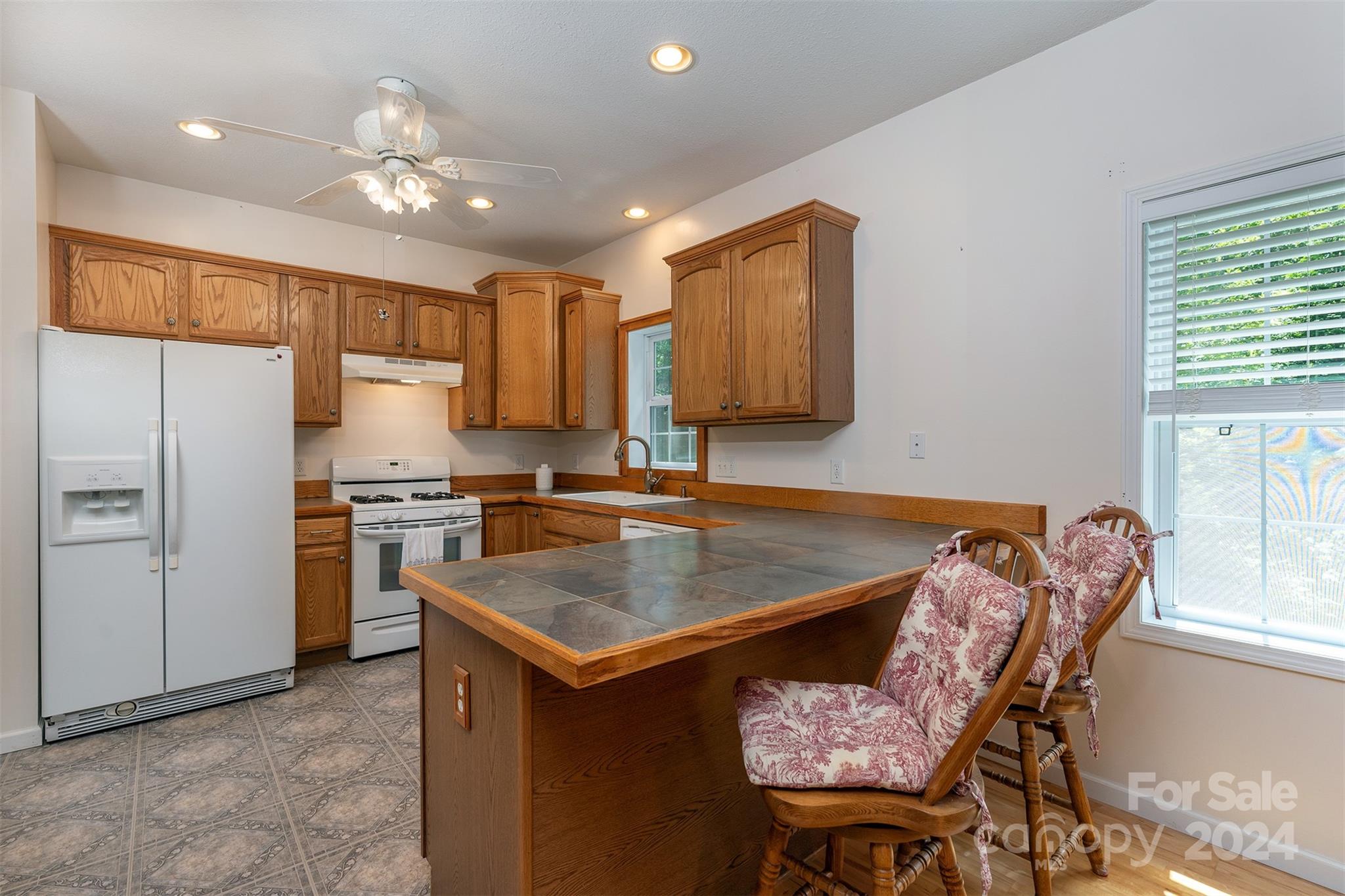 488 Anders Road Zirconia, NC 28790 - Photo 14 of 48 a kitchen with a table chairs refrigerator and microwave