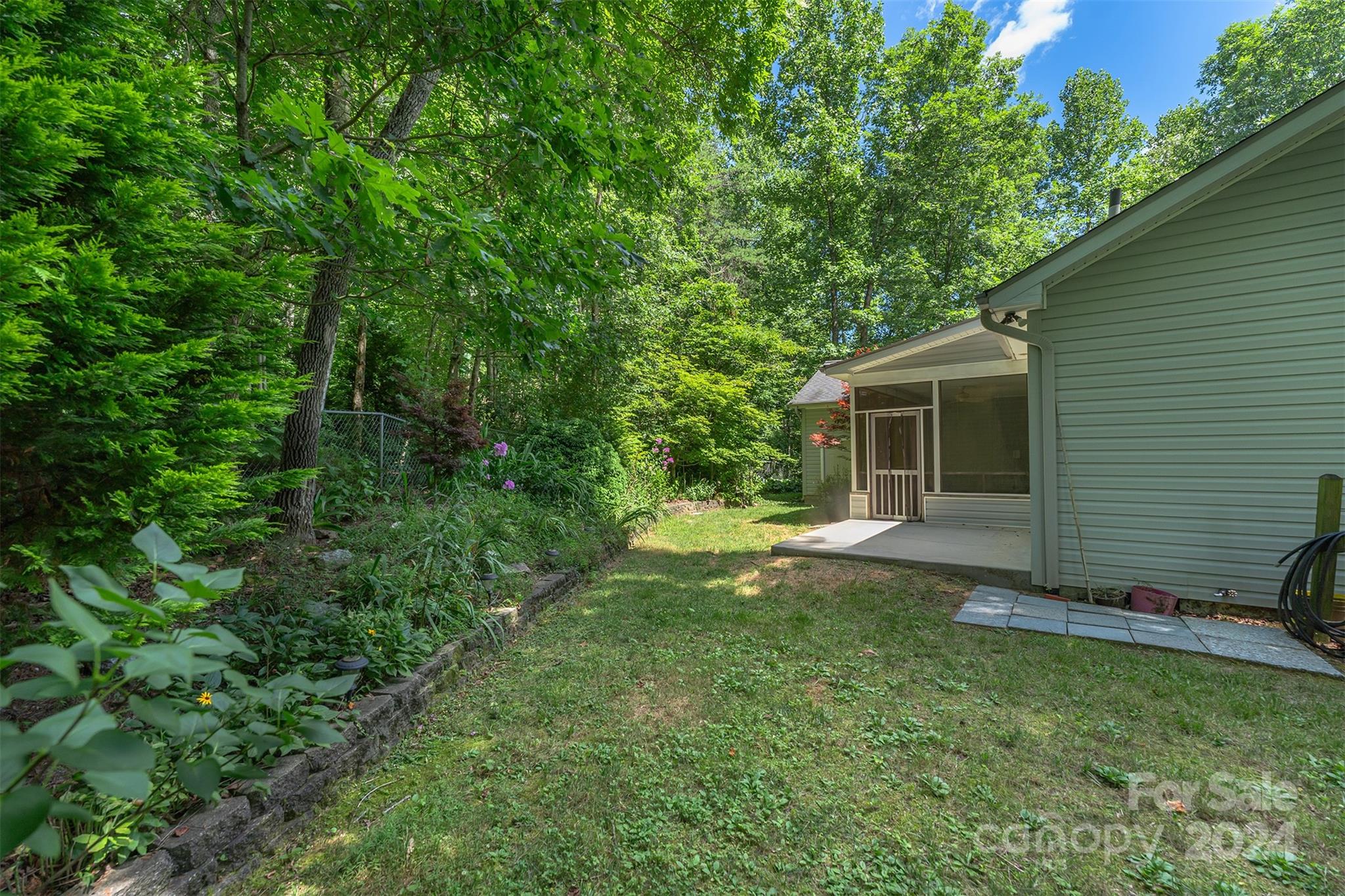 488 Anders Road Zirconia, NC 28790 - Photo 39 of 48 a view of a backyard with a large tree