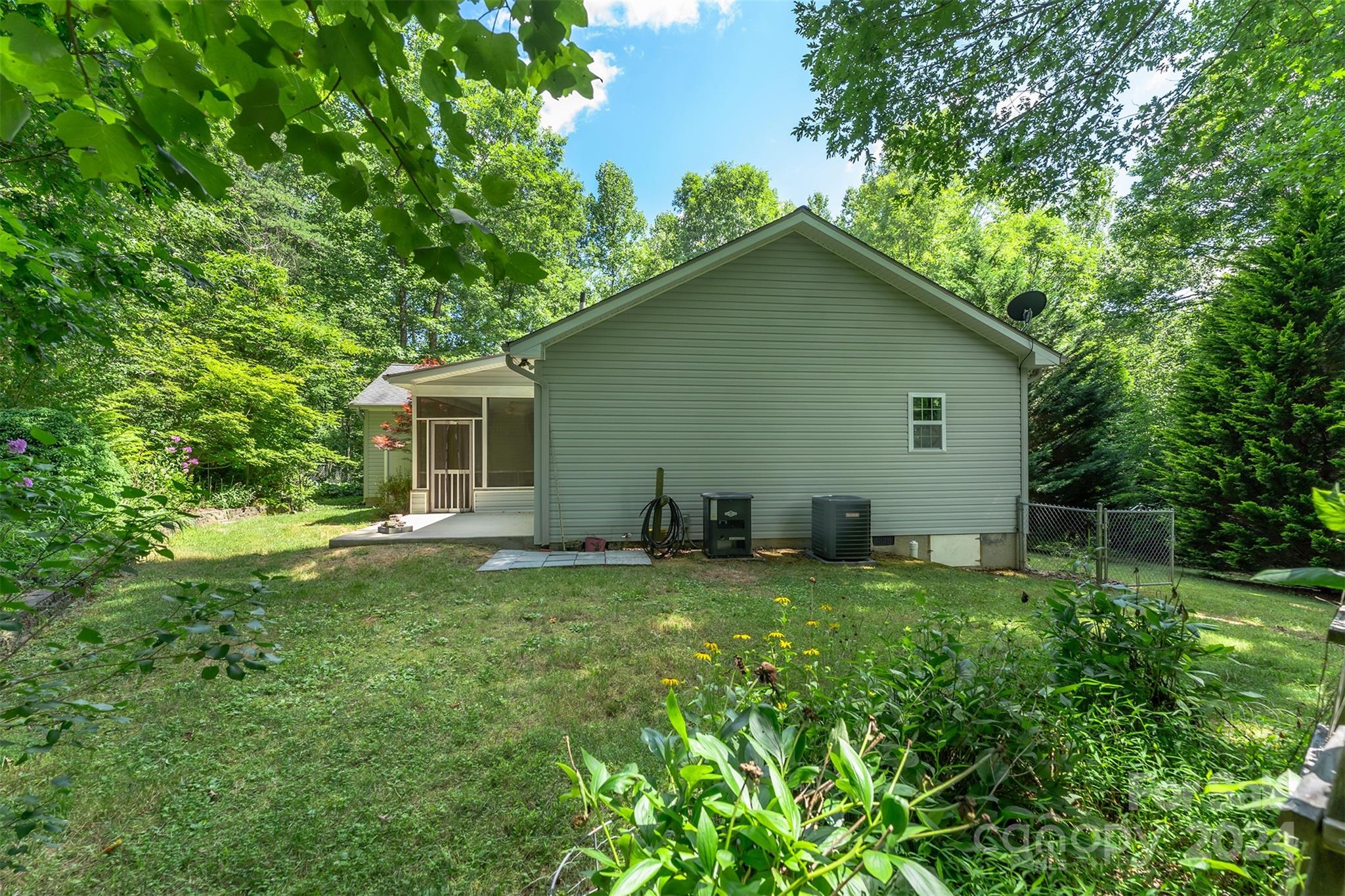 488 Anders Road Zirconia, NC 28790 - Photo 40 of 48 a backyard of a house with table and chairs