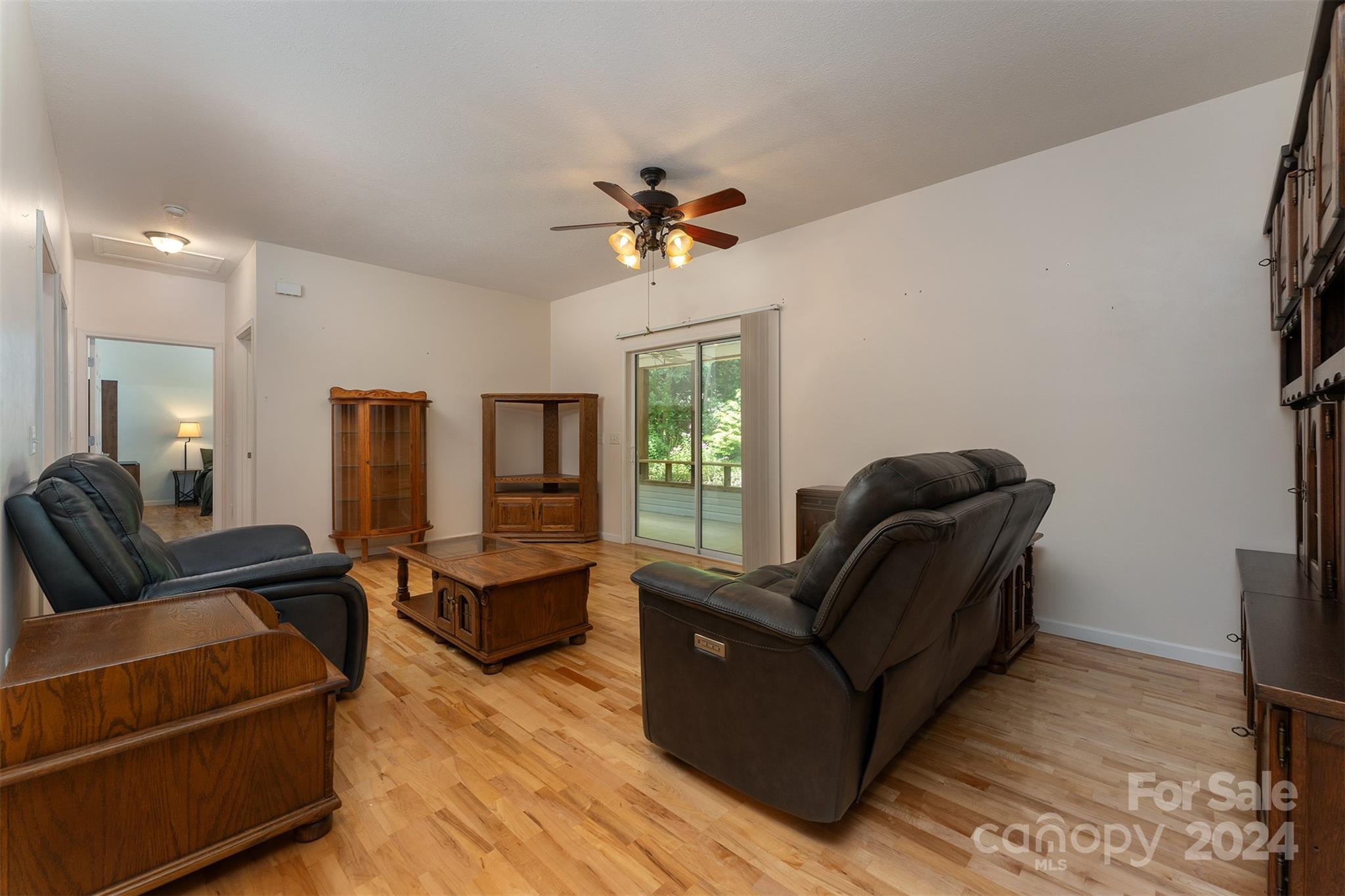 488 Anders Road Zirconia, NC 28790 - Photo 10 of 48 a living room with furniture and a chandelier