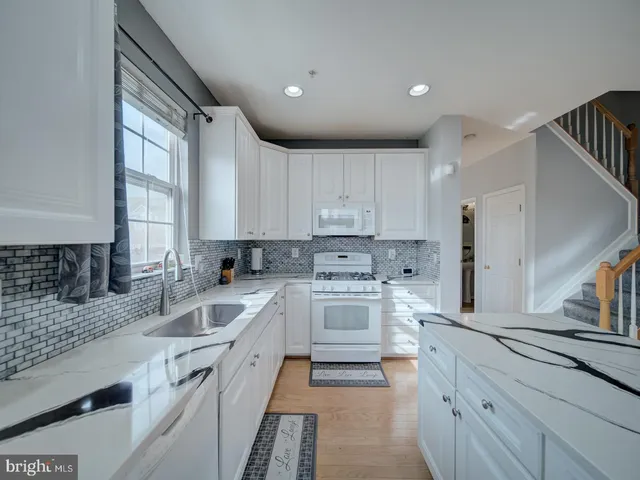 a view of livingroom with furniture flat screen tv and staircase