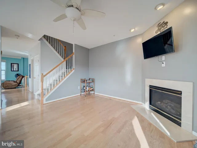 a view of an empty room with window and fireplace