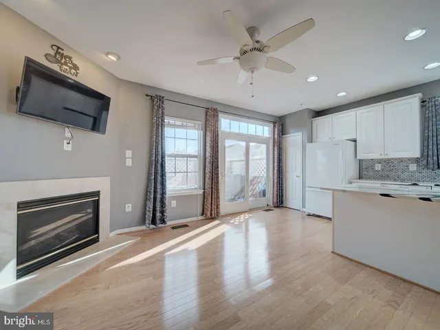 a view of a dining room with furniture a chandelier and wooden floor