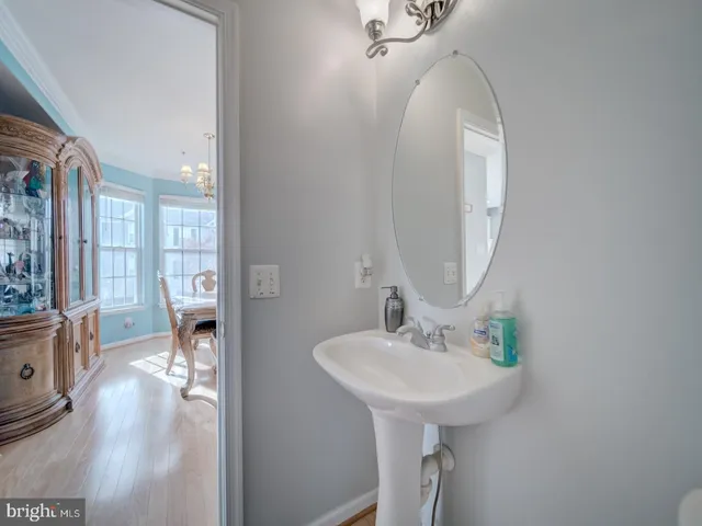 a view of a hallway to a livingroom with a chandelier