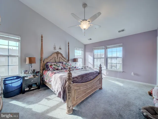 a bedroom with bed and window