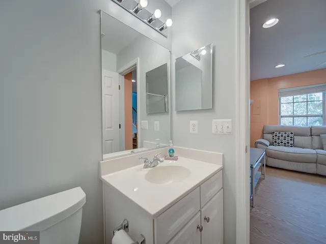 a bathroom with a sink a toilet and a mirror