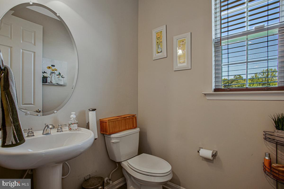 8704 Alexa Road Clinton, MD 20735 - Photo 21 of 42 Main-level half bath with pedestal sink