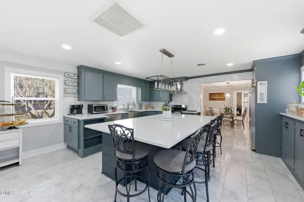 a large kitchen with a table and chairs