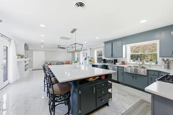 a large kitchen with a table and chairs in it
