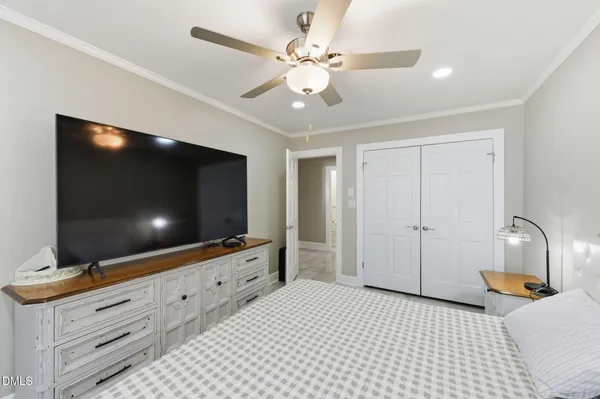 a bedroom with a bed and a chandelier