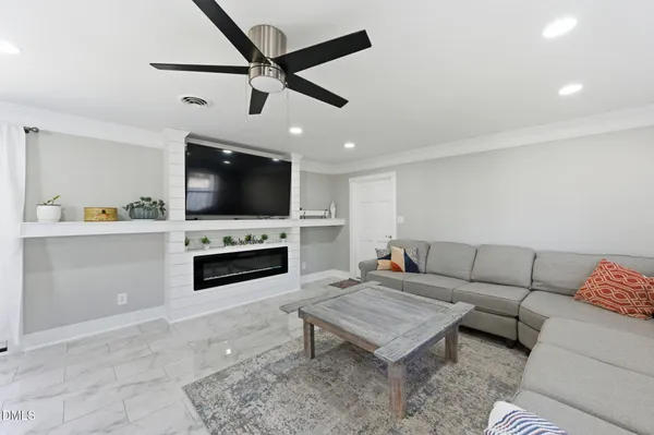 a living room with furniture and a fireplace