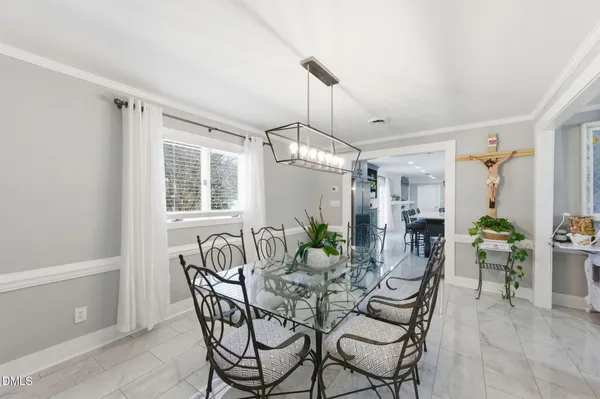 a view of a dining room with furniture and chandelier