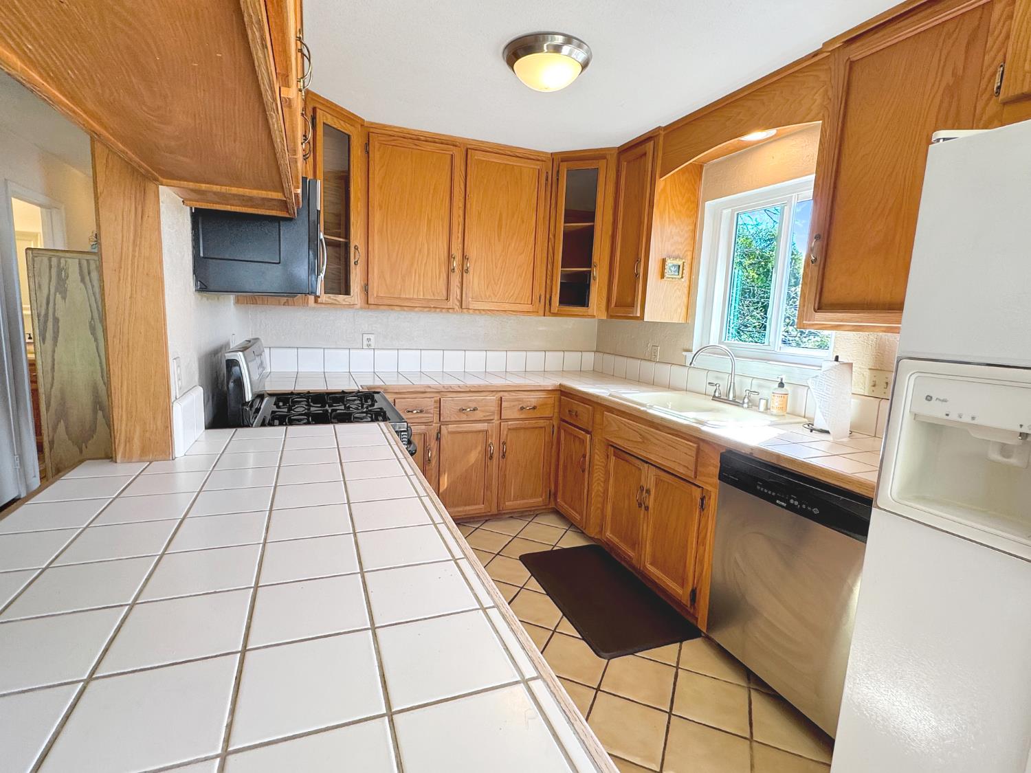 10100 Indian Hill Road Newcastle, CA 95658 - Photo 11 of 41 a kitchen with a sink a stove top oven a counter top space and cabinets
