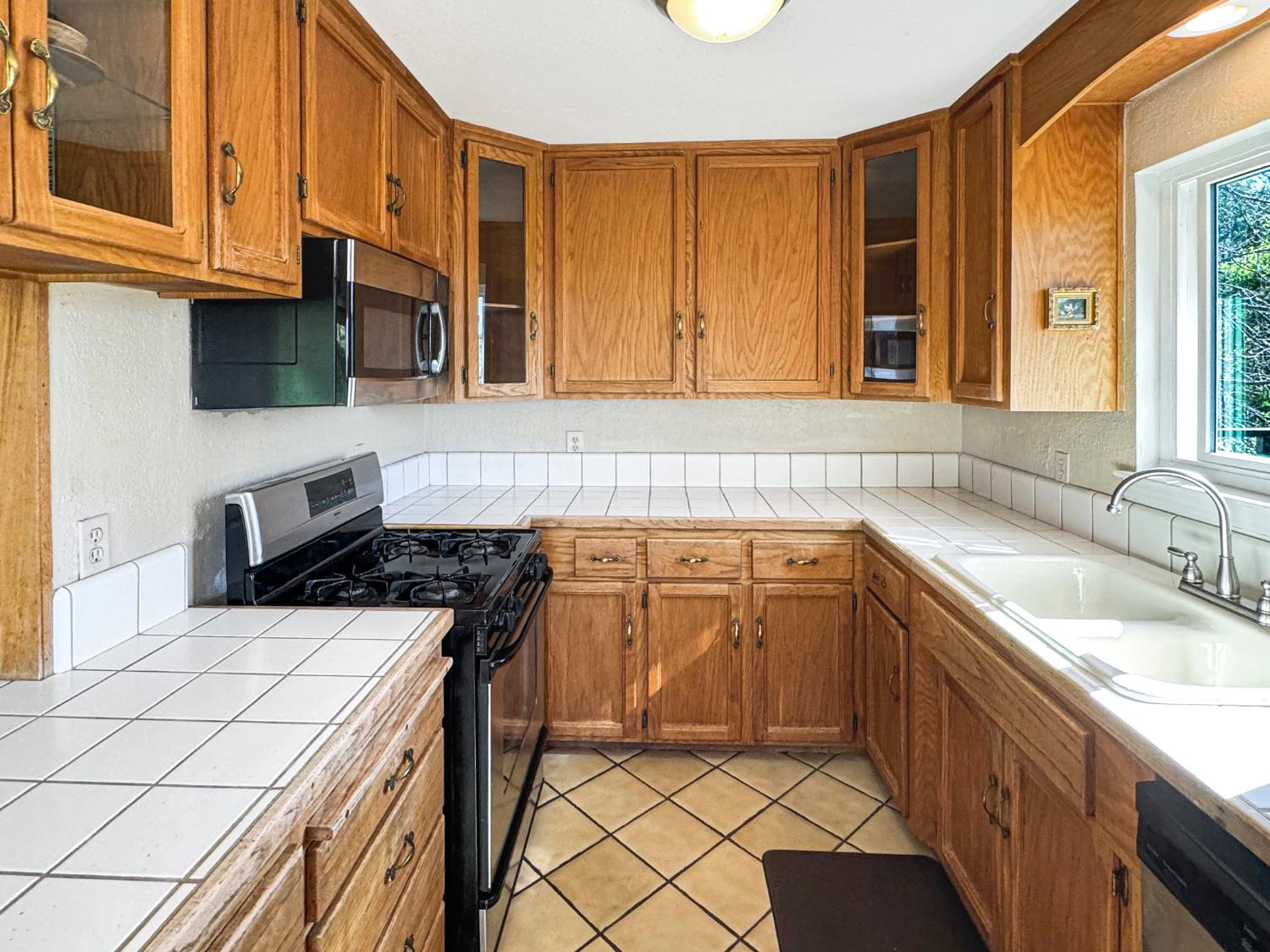10100 Indian Hill Road Newcastle, CA 95658 - Photo 12 of 41 a kitchen with a sink stove and cabinets