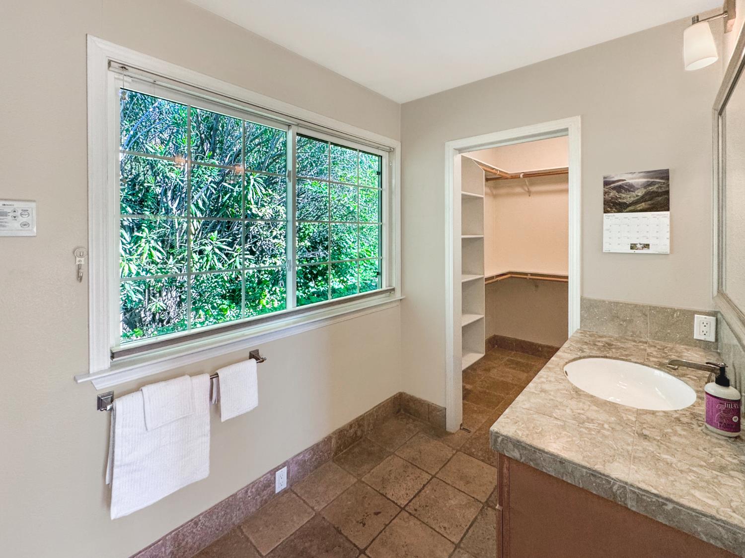 10100 Indian Hill Road Newcastle, CA 95658 - Photo 23 of 41 a bathroom with a granite countertop sink and a mirror