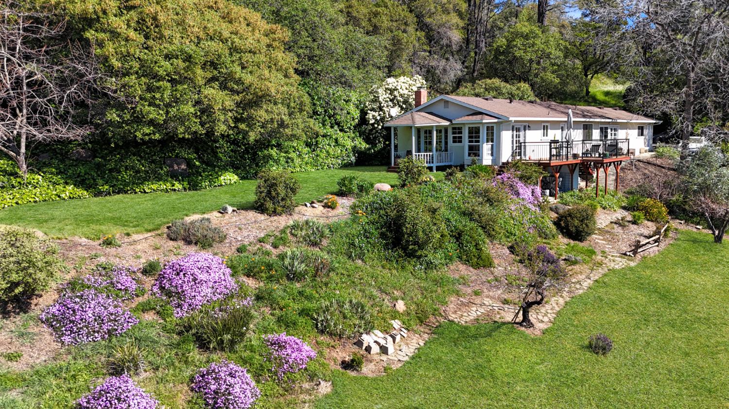 10100 Indian Hill Road Newcastle, CA 95658 - Photo 3 of 41 a front view of a house with a yard and fountain
