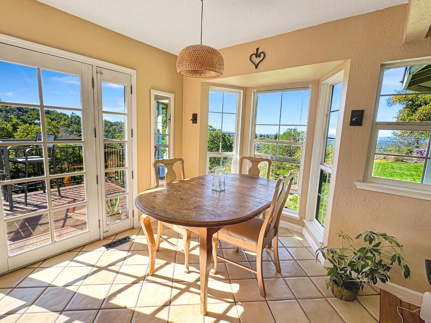 10100 Indian Hill Road Newcastle, CA 95658 - Photo 5 of 41 a view of a dining room with furniture large windows and wooden floor