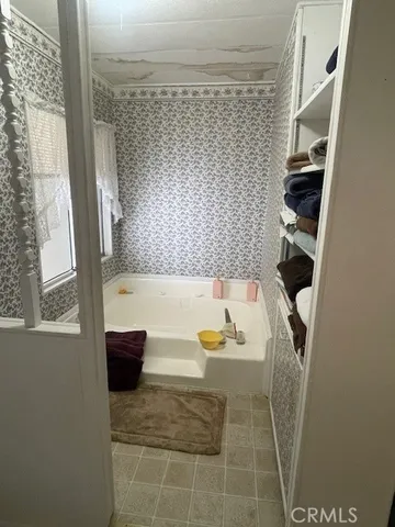 a view of a livingroom with furniture and a window